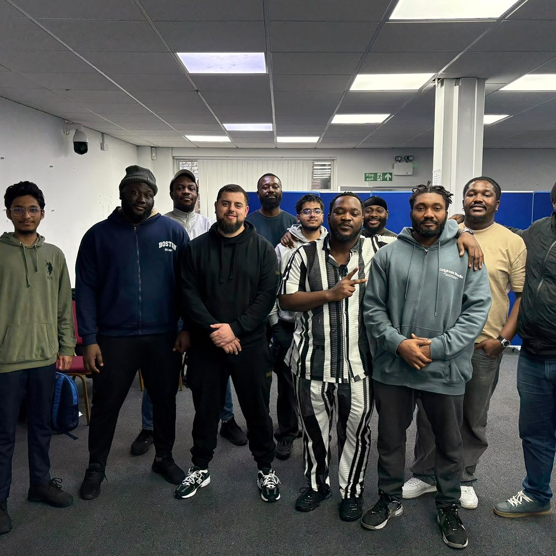 A course group standing together in the training room at the end of their course.